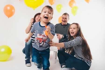 a group of five people on the background of balloons. Family photo at the partyの写真素材