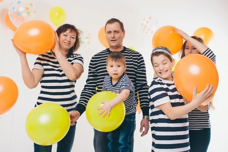 a group of five people on the background of balloons. Family photo at the partyの写真素材