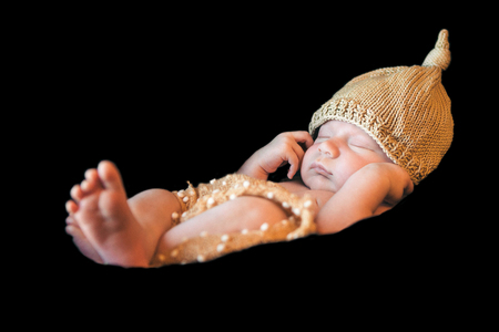 portrait of newborn baby in a hat on a black background. Newborn fashionの写真素材