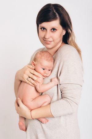 portrait of newborn baby lying on the hands of parents. Mother and sonの写真素材
