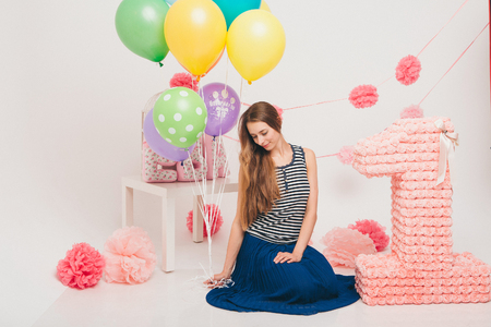 The blonde woman with the coloured balls on a white background.の写真素材