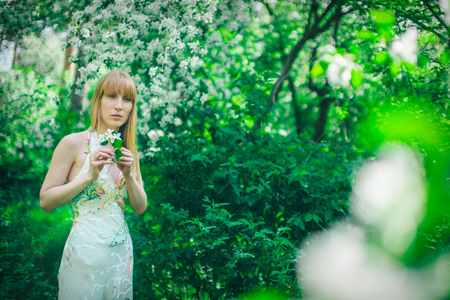 Portrait of a girl on a background of green foliageの写真素材