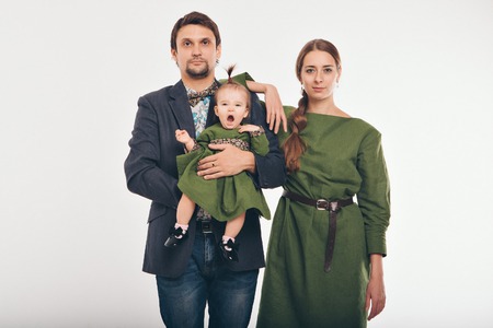 Family photo: mom, dad, child. Fashion in green and greyの写真素材