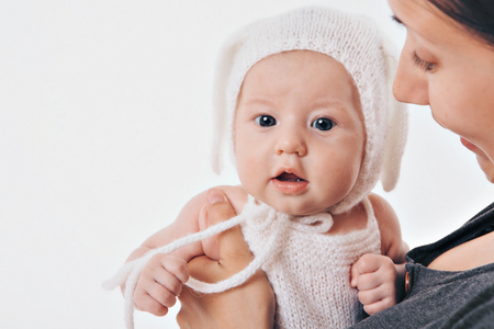 Portrait of a young child in a beige cap with earsの写真素材