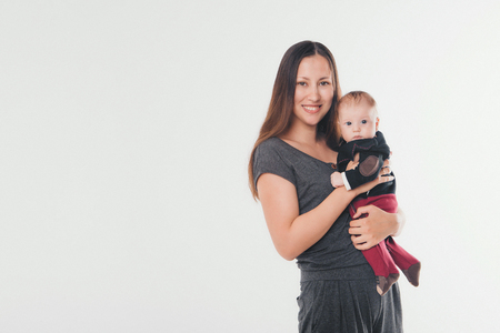 mother holds on the hands of his bare baby. Woman with a baby in her arms.の写真素材