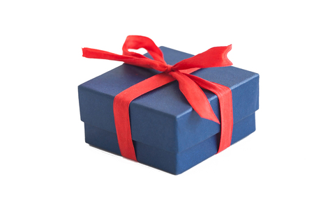 Blue gift box with red bow on white background. Isolated surprise photoの写真素材
