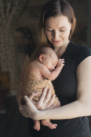 baby on the hands of mother. woman and childの写真素材