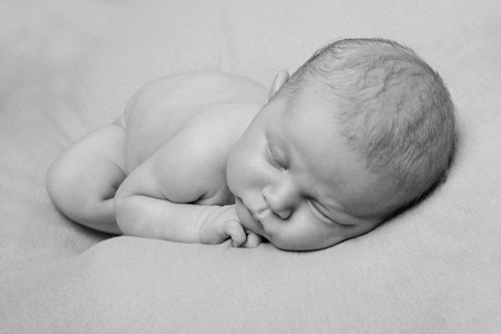 portrait of newborn baby lying on the hands of parentsの写真素材