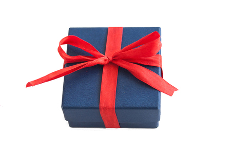 Blue gift box with red bow on white background. Isolated surprise photoの写真素材
