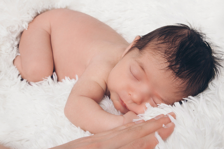 Portrait of newborn baby on a white background.の写真素材