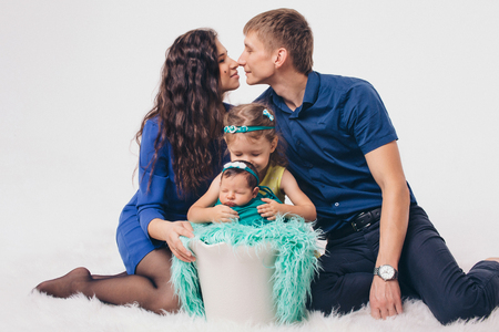 Family portrait on the floor on white backgroundの写真素材