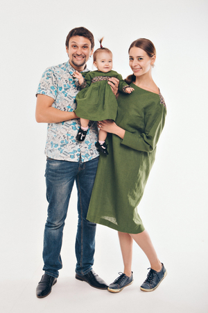 Family photo: mom, dad, child. Fashion in green and greyの写真素材