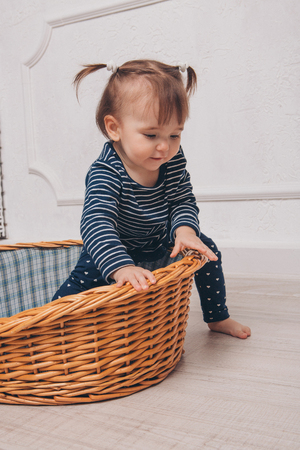 little girl learns to get out of the basketの写真素材