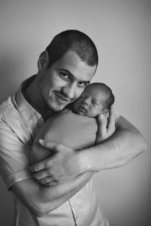 Dad holds the baby in his arms. The concept of educating the father of young children, Happy childhood, a friendly family. Isolated on white background.の写真素材