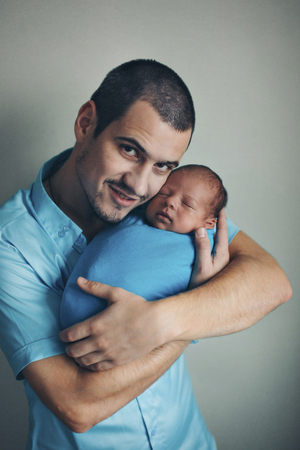 Dad holds the baby in his arms. The concept of educating the father of young children, Happy childhood, a friendly family. Isolated on white background.の写真素材