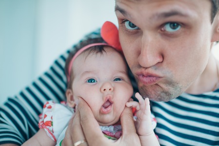 Dad holds the baby in his arms. The concept of educating the father of young children, Happy...