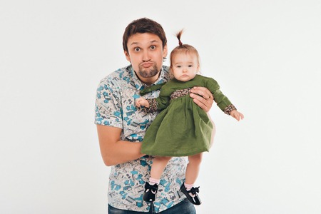 Dad holds the baby in his arms. The concept of educating the father of young children, Happy childhood, a friendly family.の写真素材