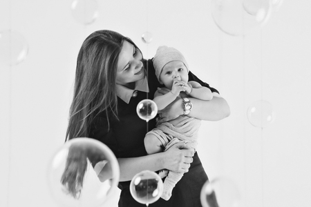 newborn baby in the arms of the mother. Woman holding a childの写真素材