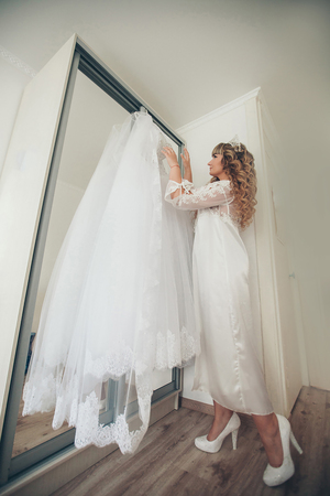 the bride is trying on a wedding dress. wedding fashionの写真素材