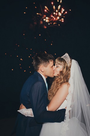 the bride and groom on the background of fireworksの写真素材