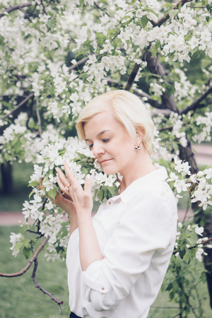 girl with a bouquet of flowers. Bride sniffing bouquetの写真素材