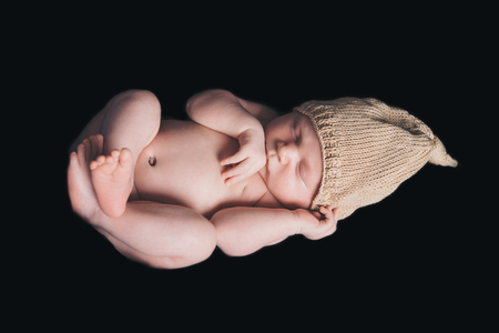 portrait of newborn baby in a hat on a black background. Newborn fashionの写真素材