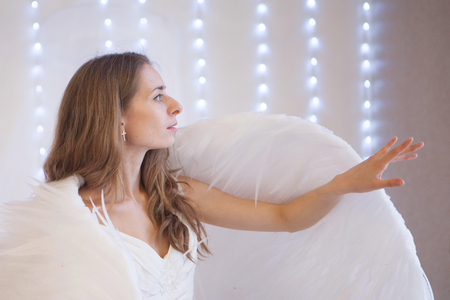 Girl in pink dress with angel wings on white background. Angel-womanの写真素材