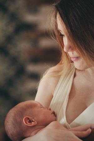 baby in the arms of the mother. Woman holding a childの写真素材