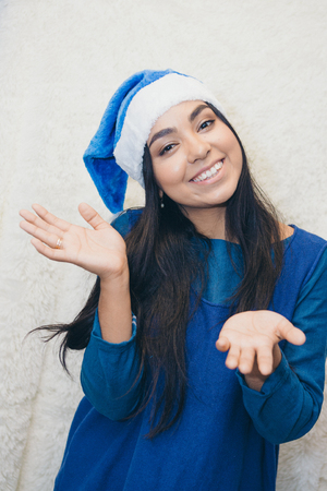 a beautiful Asian woman in blue clothes and a blue cap is fooling around in front of the camera. Russian Christmas characters Snegurochka Snow Maidenの写真素材