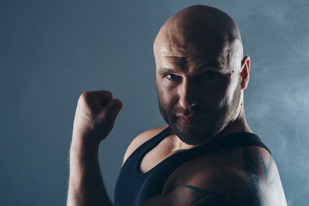 Strong naked muscular man shows off his musclesの写真素材
