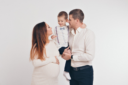 baby on the hands of parents on a white background.の写真素材