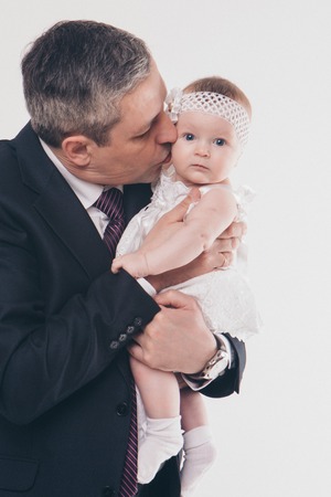 Dad holds the baby in his arms. The concept of educating the father of young children, Happy childhood, a friendly family. Isolated on white background.の写真素材