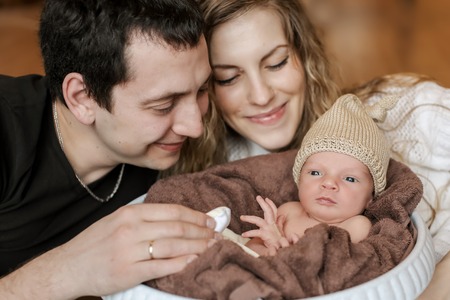 the baby on the hands of parentsの写真素材