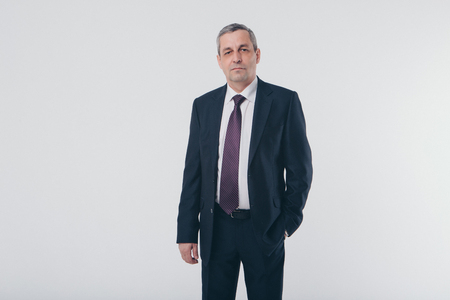 isolated photo: portrait of a smiling handsome man in a business suitの写真素材