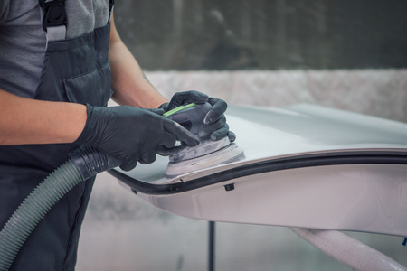 polishing machine on the surface of the black car close-upの写真素材