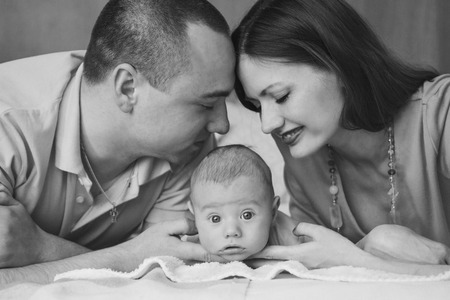 the baby on the hands of parentsの写真素材