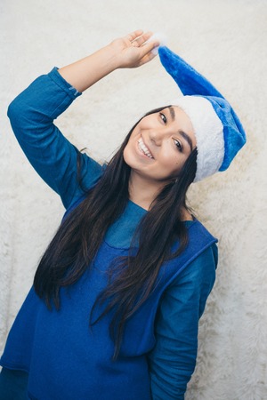 a beautiful Asian woman in blue clothes and a blue cap is fooling around in front of the camera. Russian Christmas characters Snegurochka Snow Maidenの写真素材