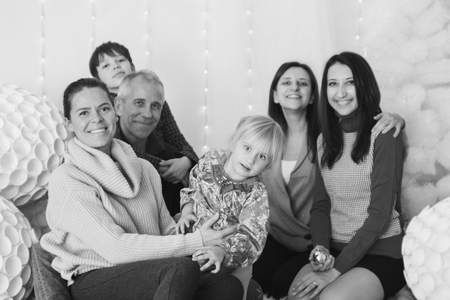 group of people: big family in the background, Christmas decorations: Christmas tree, snow, toysの写真素材