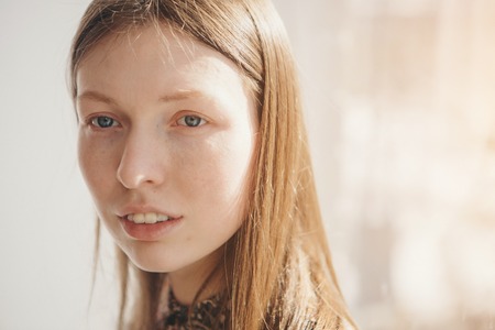 portrait of a beautiful smiling girl with long hair. Face of girl close upの写真素材