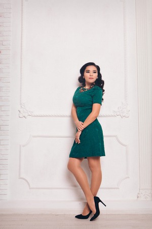 beautiful long-haired girl in long dress dancing on white backgroundの写真素材