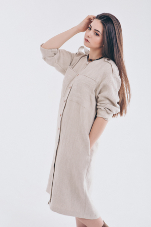 model posing in a dress on a white background. Girl shows clothesの写真素材