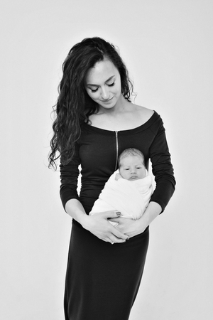 newborn baby in the arms of the mother. Woman holding a childの写真素材