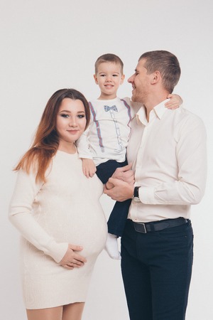 baby on the hands of parents on a white background.の写真素材