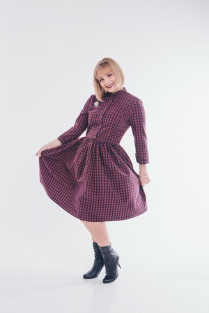 model posing in a dress on a white background. Girl shows clothesの写真素材