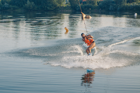 a positive person is riding on water on a skateboardの写真素材