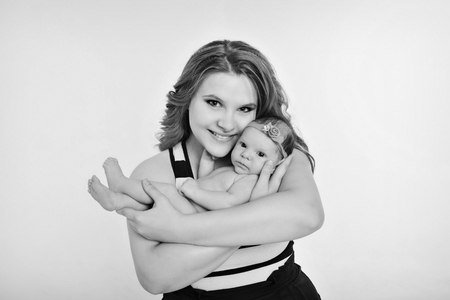 newborn baby in the arms of the mother. Woman holding a childの写真素材