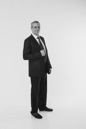 isolated photo: portrait of a smiling handsome man in a business suitの写真素材