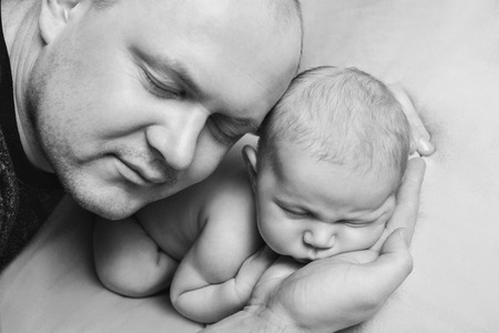 portrait of father and newborn baby face to face.の写真素材