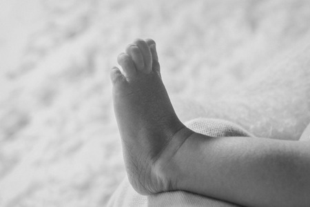 the feet of a newborn baby close-upの写真素材