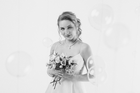 girl with a bouquet of flowers. Bride sniffing bouquetの写真素材